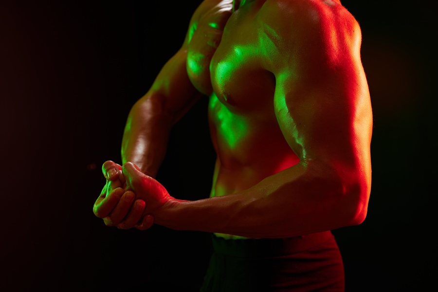 Man Bodybuilder Posing Muscles With Nude Fitness